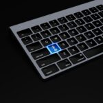 Writing website copy with AI assistance on a keyboard