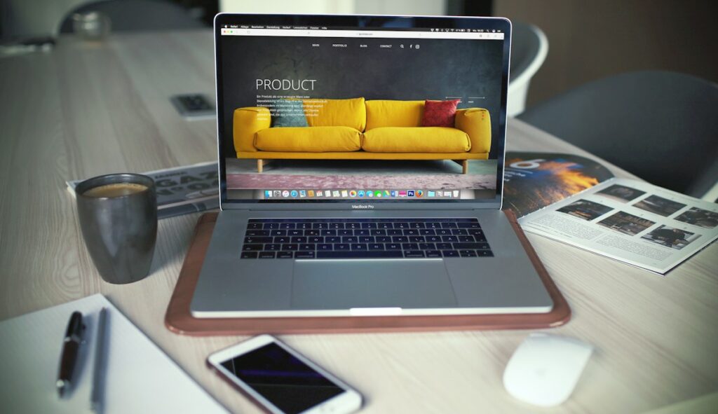 Designer refining an Elementor page structure on a MacBook