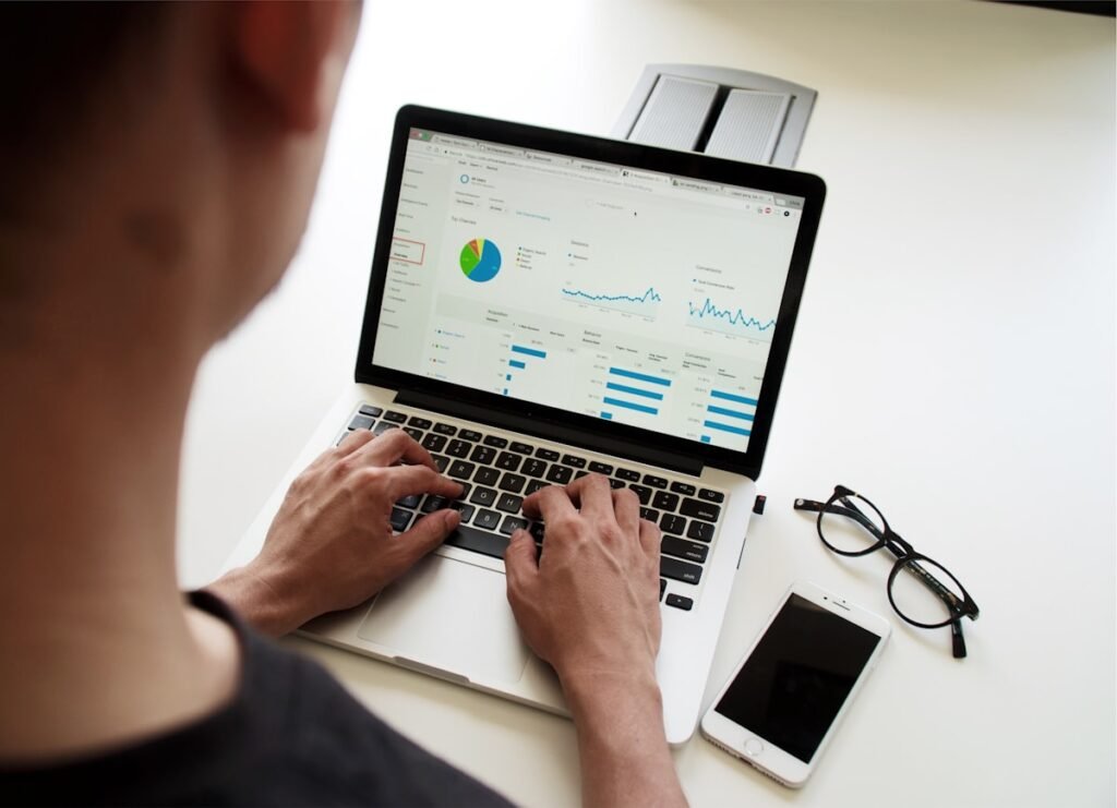 Business owner reviewing website enquiry data on a laptop